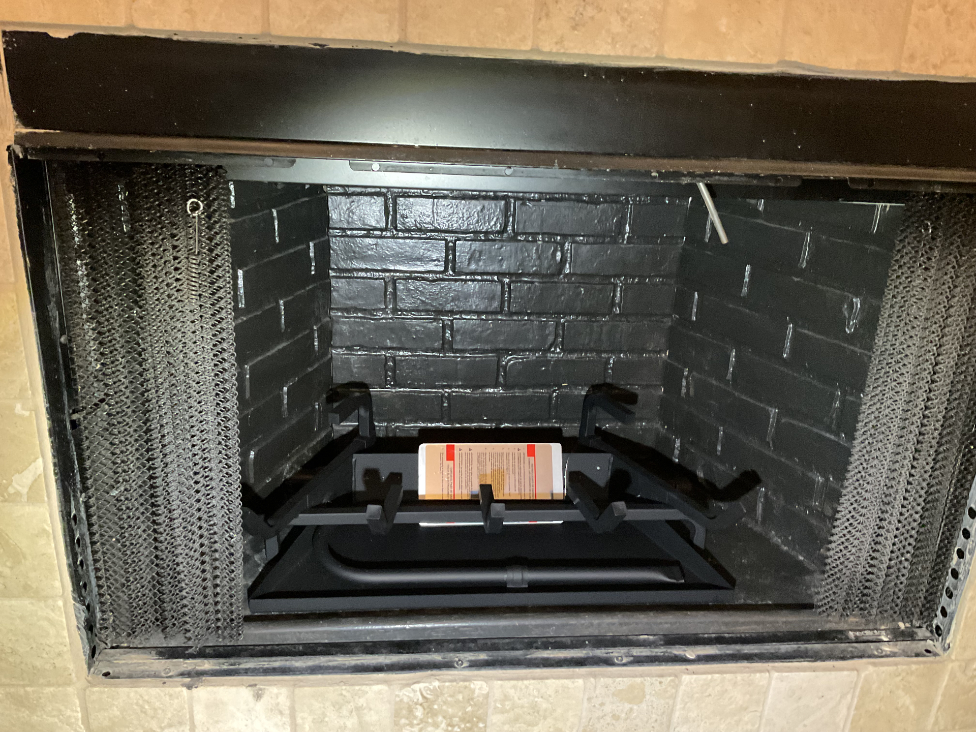 Black firebox showing the gas log burner and grate assembly