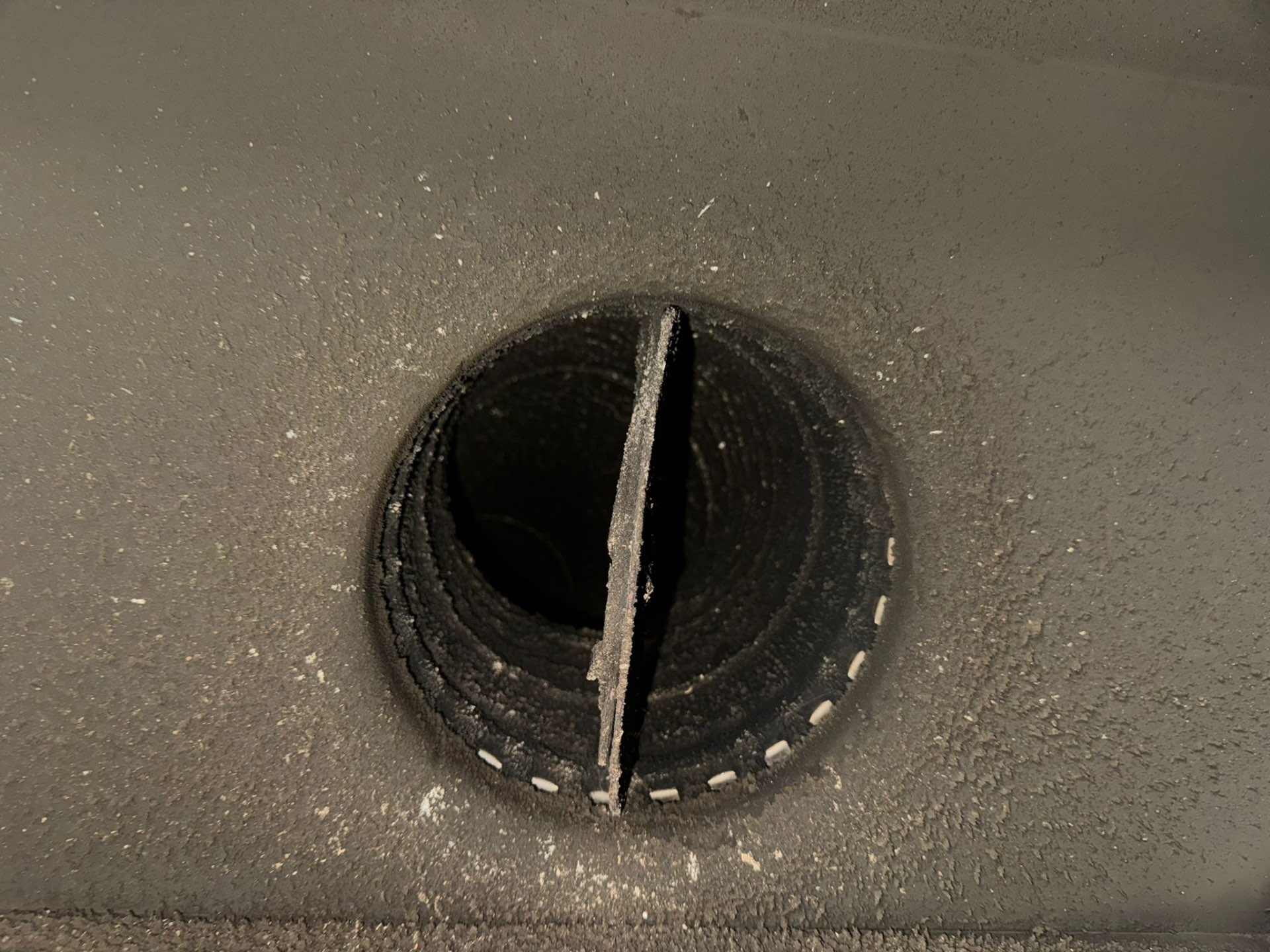 Creosote buildup visible inside a chimney flue before cleaning